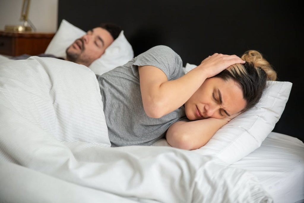 man snoring in bed