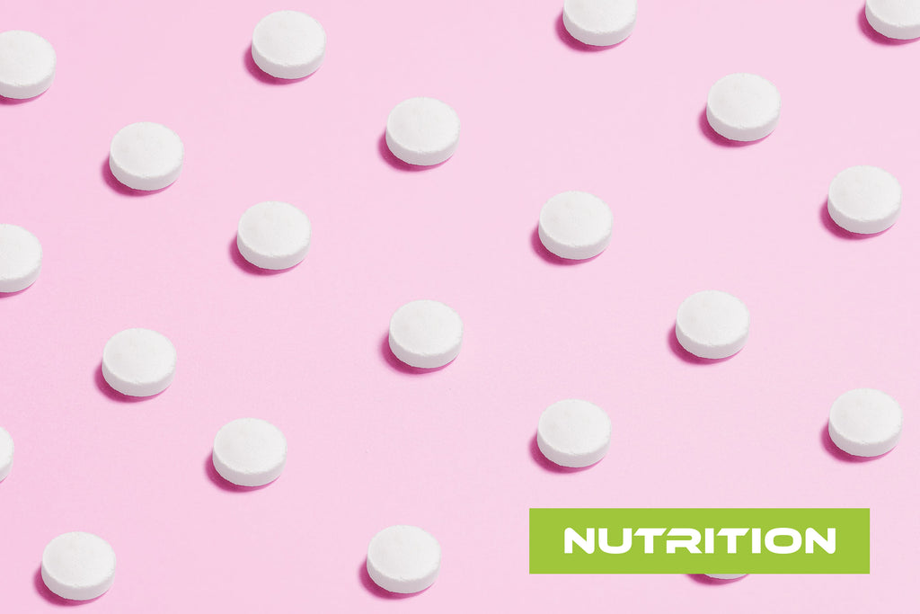 White sweetener tablets on a pink background