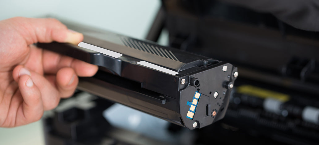 An employee changing a toner cartridge