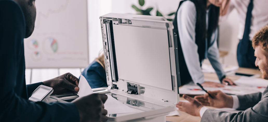 An employee scanning a document on an MFP