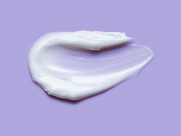 Lotion smeared on purple background