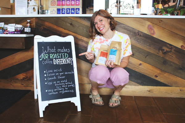 elisa in front of air roasted sign