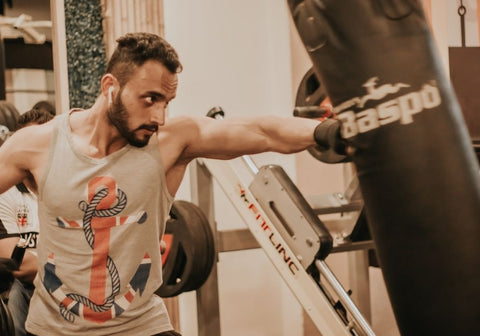 man using boxing bag in gym