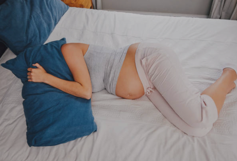 Pregnant women in bed with a pregnancy maternity pillow