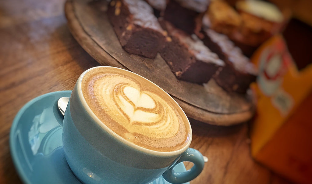 Coffee cup and brownie in the background