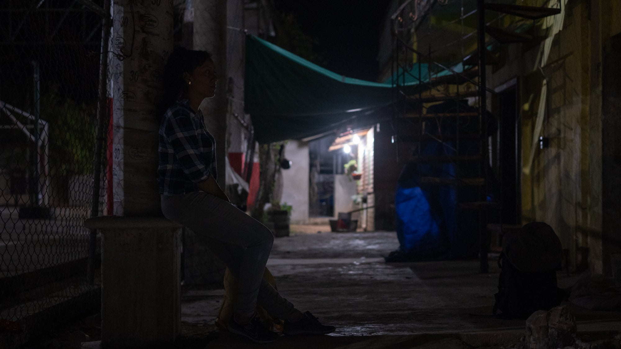 Yaz waits in front of home in Santiago Cuixtla, Oaxaca.