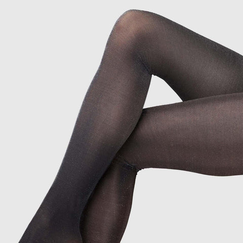 Legs with the blackish grey Cornelia Shimmery Tights from Swedish Stockings.