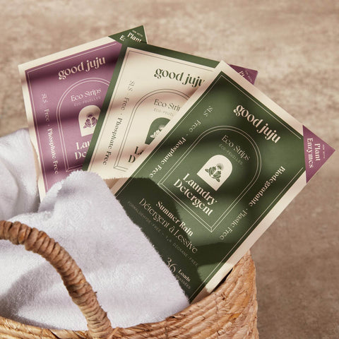 Three packages of Laundry Detergent Strips from Good Juju in a basket.