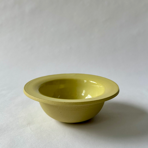 A mustard yellow glazed stoneware clay bowl Snack Bowl from Ekua