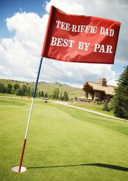 A Moonpig Father's Day card that's a picture of a golf course with a red flag in a hole. The flag says "Tee-rific dad. Best by par."