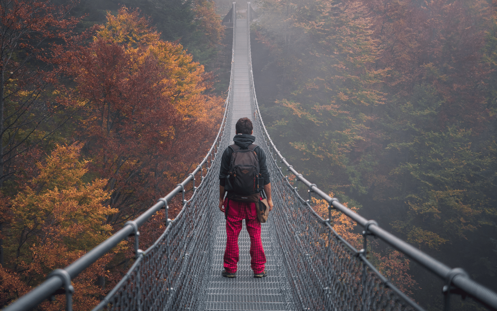 person standing on bridge