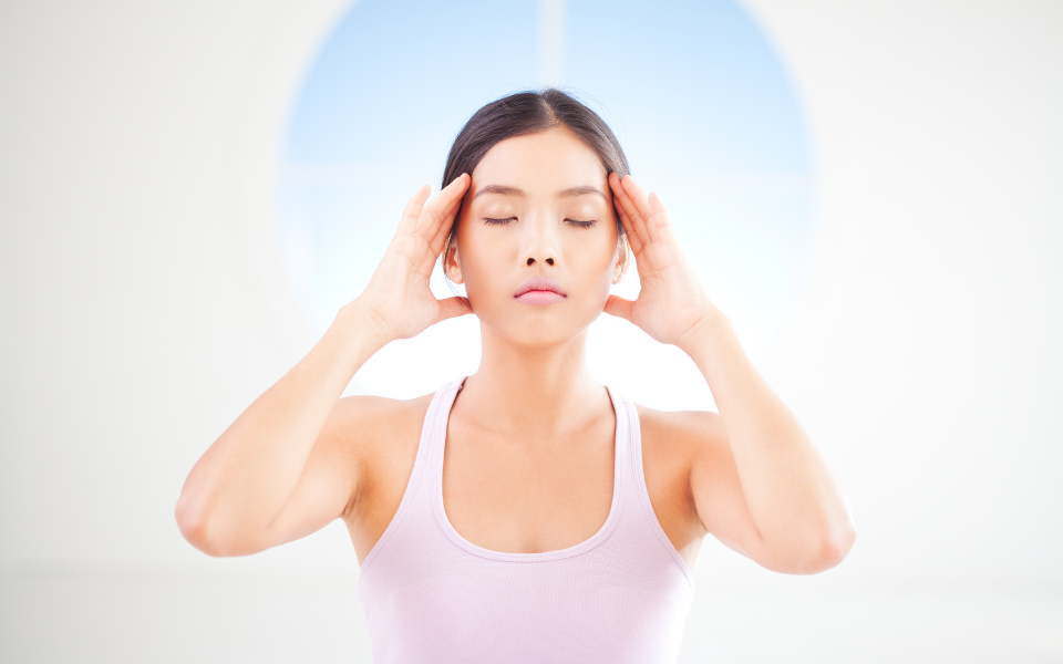 woman holding head after taking mushroom supplements