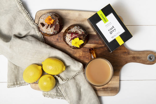 Earl Grey tea with lemon and cakes on a board