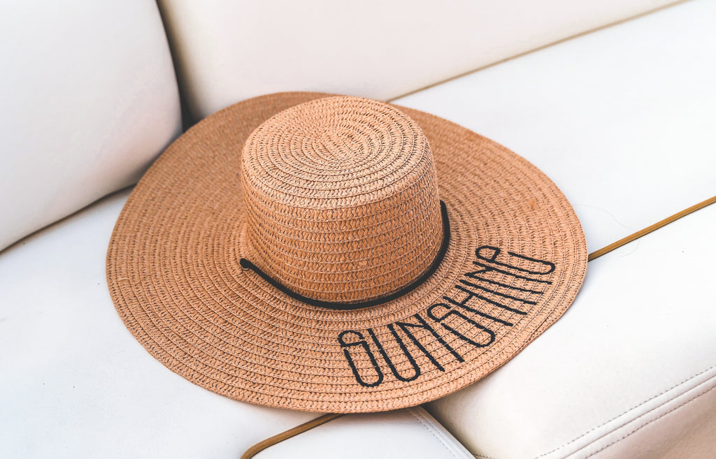 beach hat on a white sofa