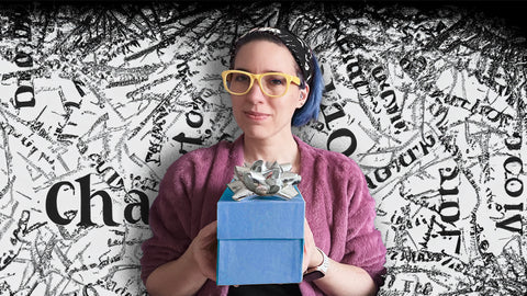 Calm woman holding a gift in front of chaotic black and white background