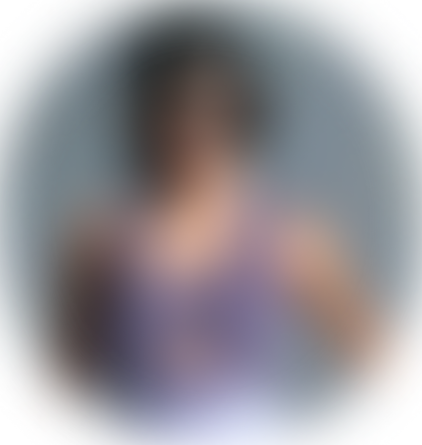 Blurry image of a person outdoors with greenery in the background.