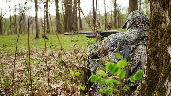 Turkey hunter in full camo holding a shotgun