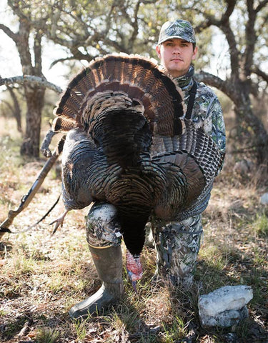 Hunter posing with his turkey