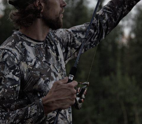 Man fishing in camo hunting clothes