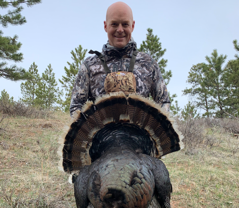 Man showing success on turkey hunt