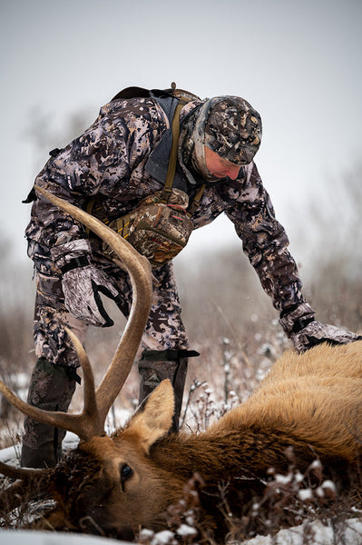 Man in cold weather hunting gear with elk