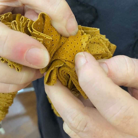 checking the weight and durability of leather for a ruffle necklace