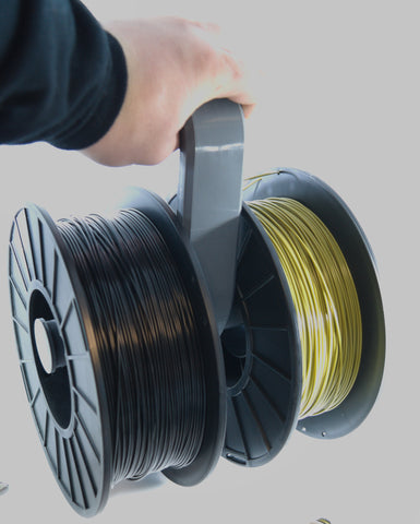 A 3D printed filament hanger made from grey PETG. Shown holding two 1kg spools of filament.
