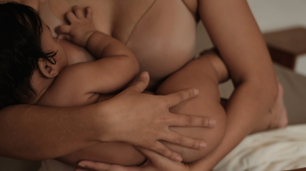 breastfeeding mom feeding son in her arms