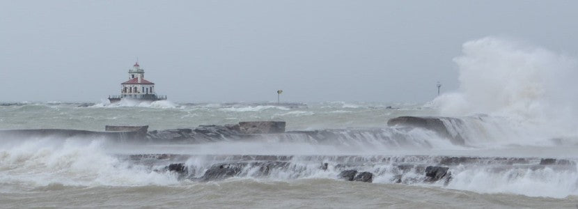  Beauty and the Beast rushing waves and lighthouse in distance presented by H Lee White Maritime Museum near Oswego NY