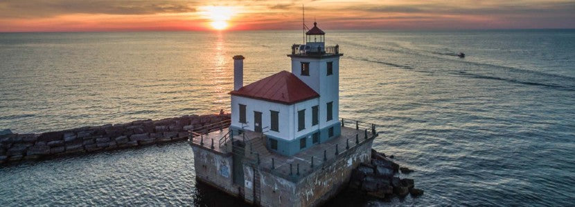  Wayne Kirby Lighthouse at sunset presented by H Lee White Maritime Museum near Oswego NY