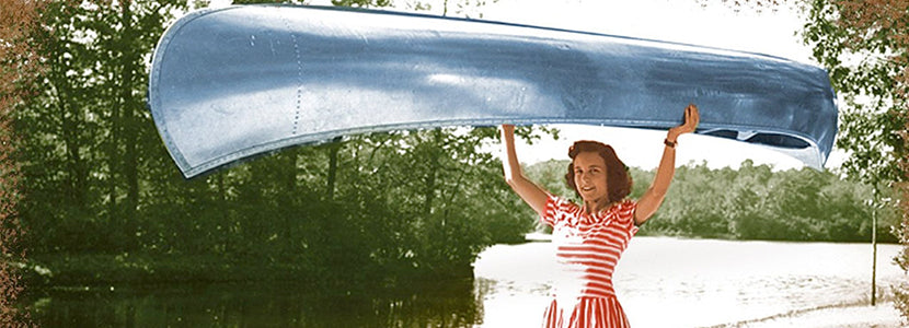 aluminum hulls presented by h lee white maritime museum near oswego ny image of vintage woman holding canoe over her head