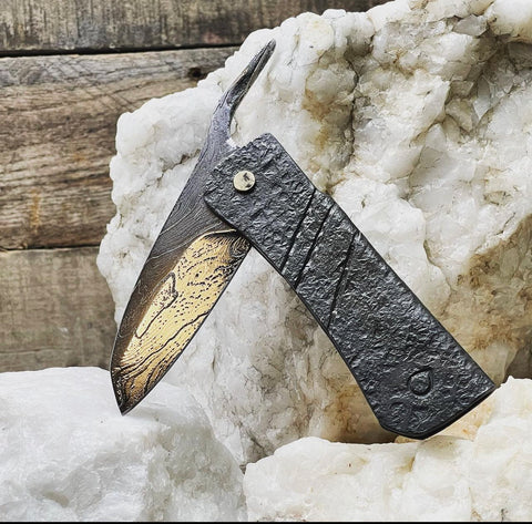 Damascus friction folder with a mild steel handle