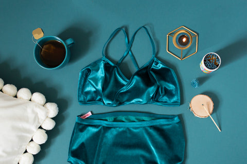 teal velvet lingerie set on teal backdrop