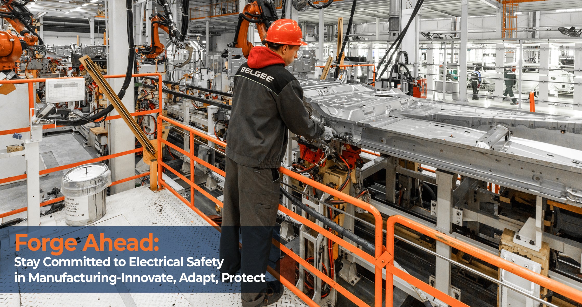 Worker at an automotive manufacturing plant focusing on assembly with emphasis on electrical safety and risk management in an industrial setting.