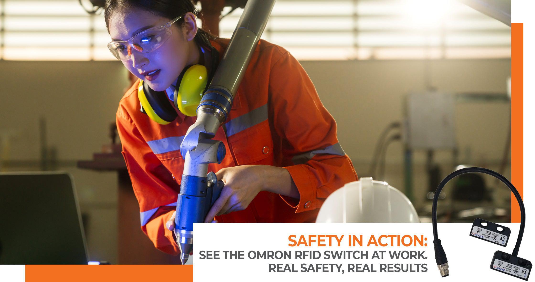 Focused technician using Omron RFID switch for safety monitoring on automated equipment in an industrial setting