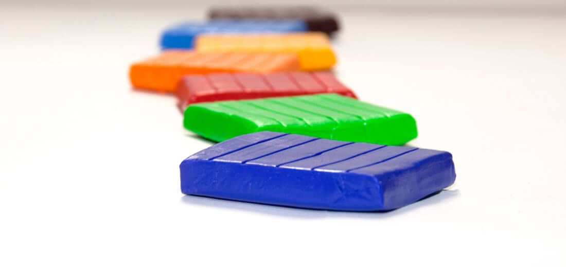 Five slabs of various colours of polymer clay.