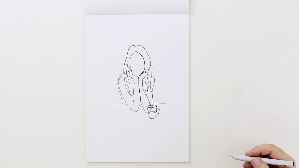 Continuous line drawing of a female holding a mug, hand holds a pen at the bottom right hand side of the page.