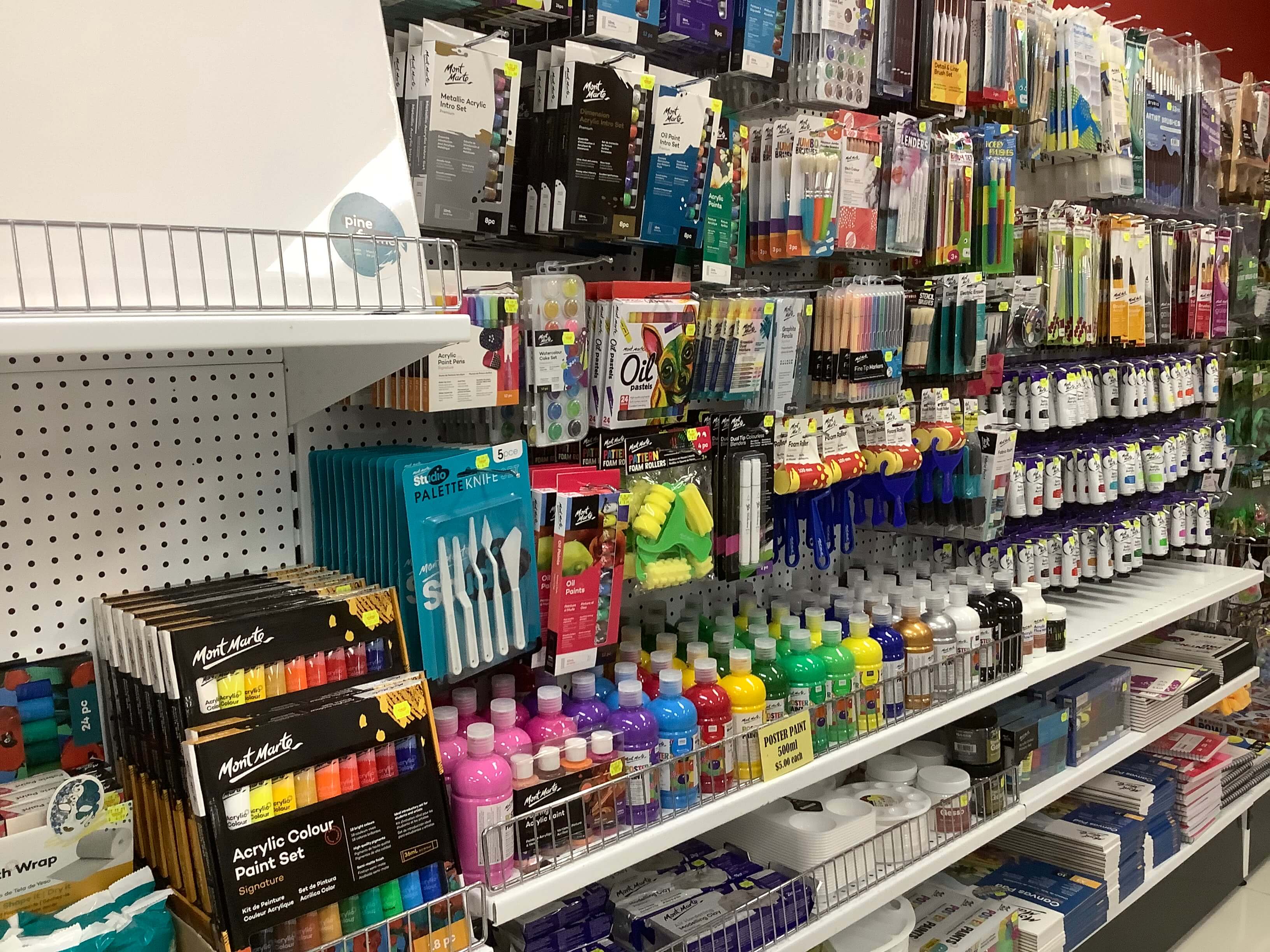 2. An image of Bronze art centre Stacks Springfield's shop aisle with various Mont Marte products stacked on the shelves.