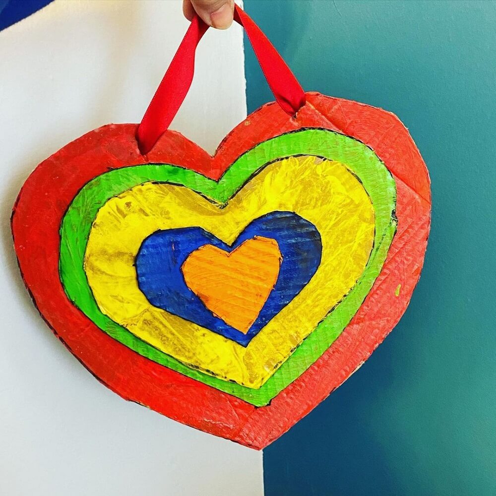 A rainbow heart made from cardboard.