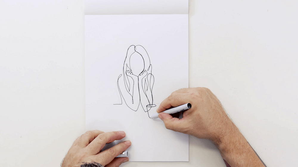 3. Drawing a continuous line portrait of a person with long hair and a cup in the foreground