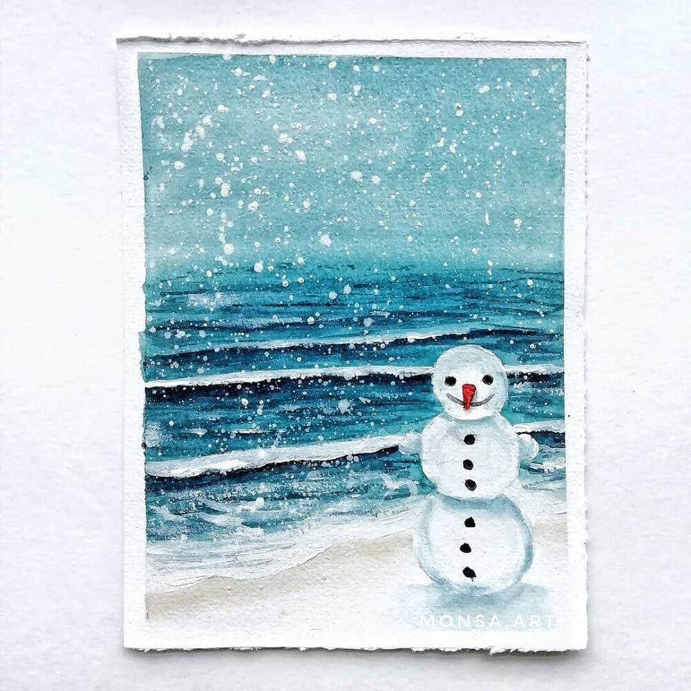 Painting of a snowman on the beach.