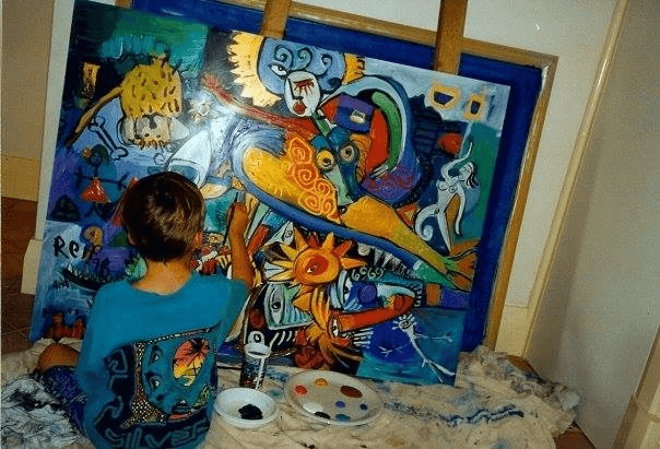 Reif at age 6, painting at home with mum.