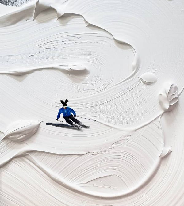 Small figurines on canvas to look like they're skiiing.