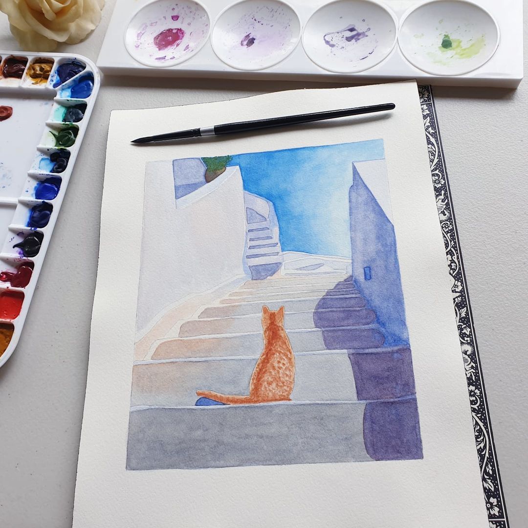 A ginger cat sitting on the stairs of Santorini painted in watercolour.