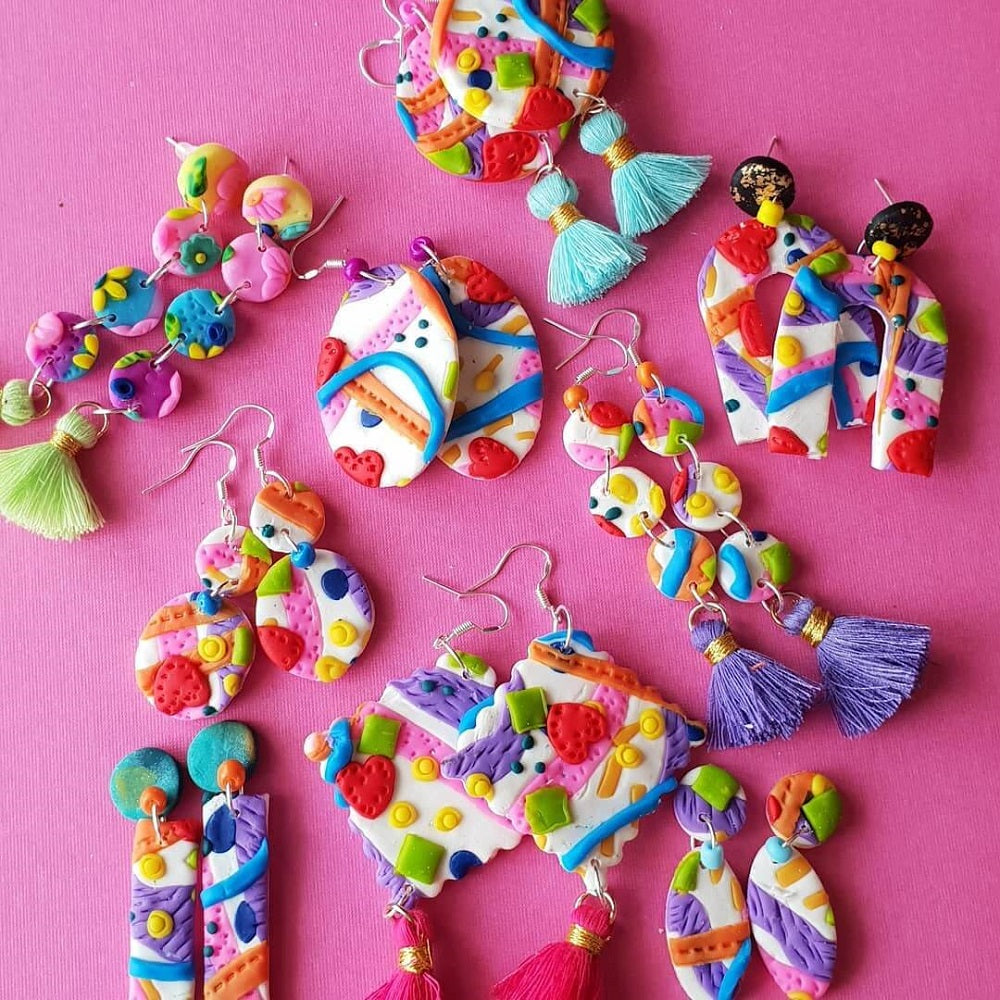 Nine pairs of coloured earrings made from patterned clay.