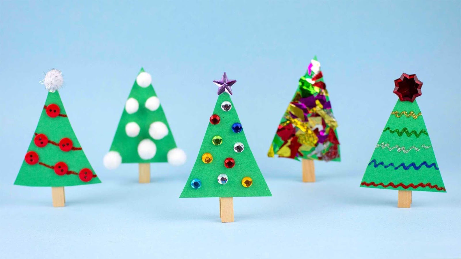 Five Christmas trees made from popsicle sticks.