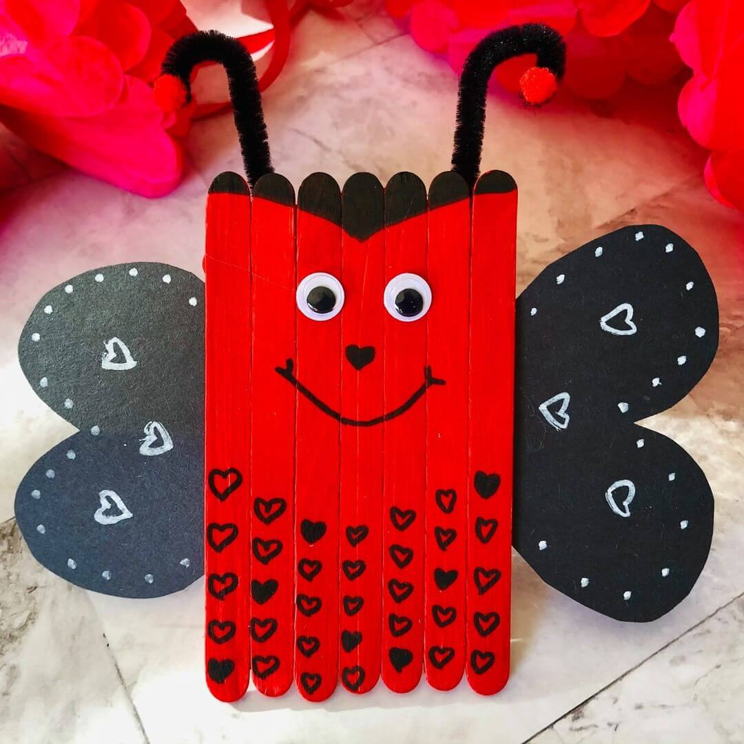 A Valentine's Day kids craft idea of a lady bug made from popsicle sticks.