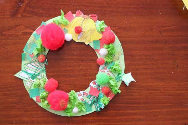 A Christmas craft wreath on a wooden table.