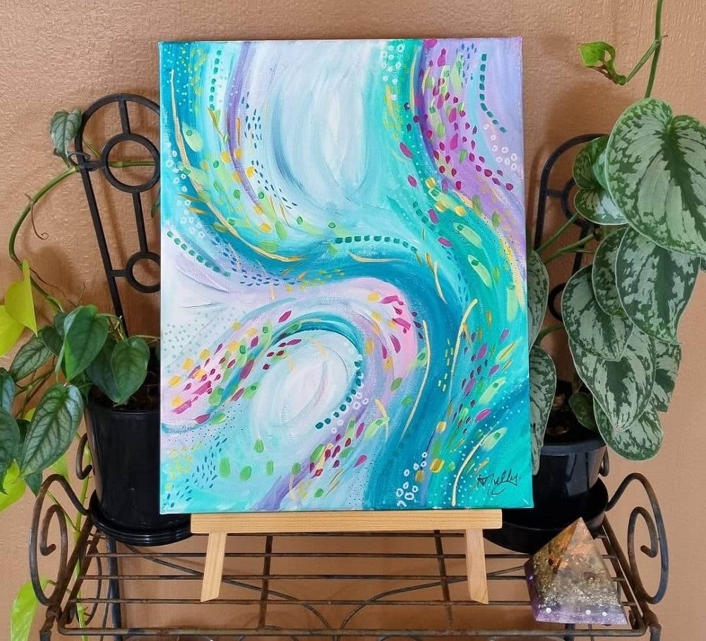 Abstract swirls of greens, blues and purples on a canvas with green pot plants on either side.