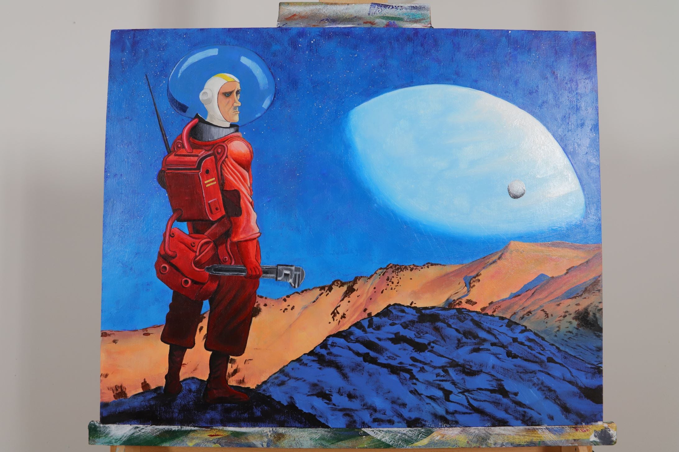 Gouache painting of an astronaut on a planet holding a wrench